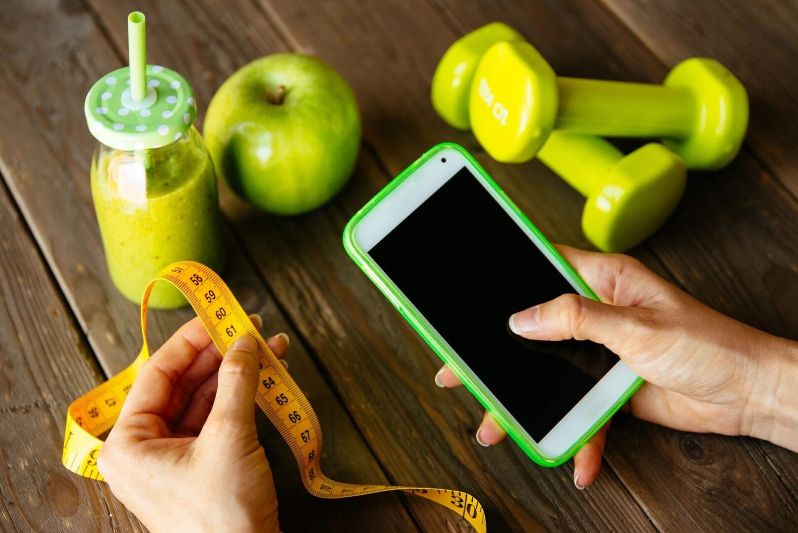 A Woman Holding a Tape and a Phone in a Hand